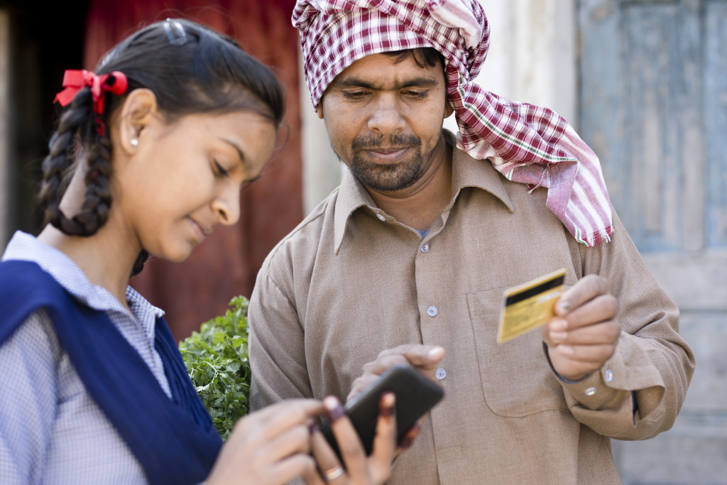 Father with daughter shopping online using credit card