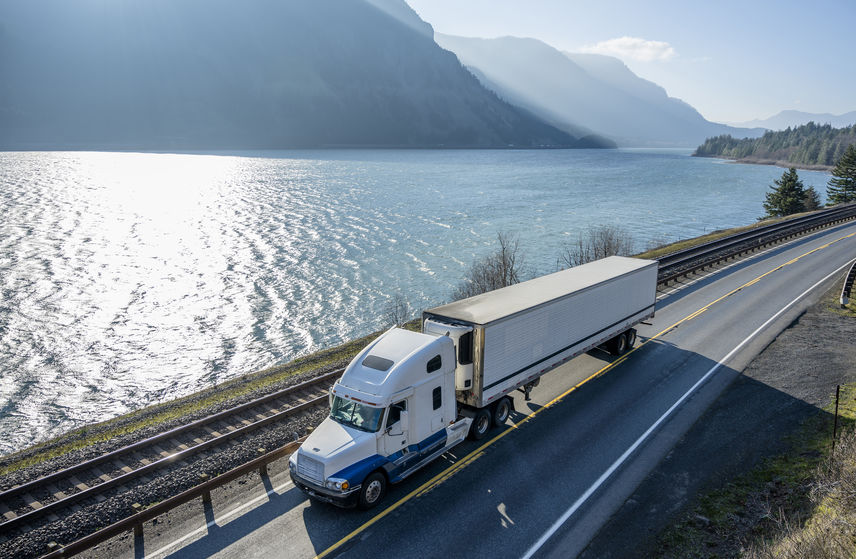 Big rig semi truck transporting cargo in refrigerator semi truck